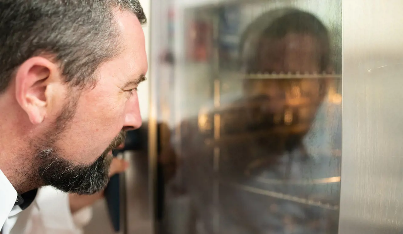 Chef looking into oven
