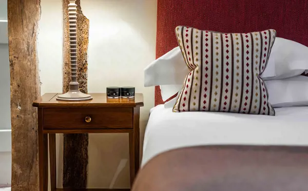 Close up on pillow on bed with bed side table